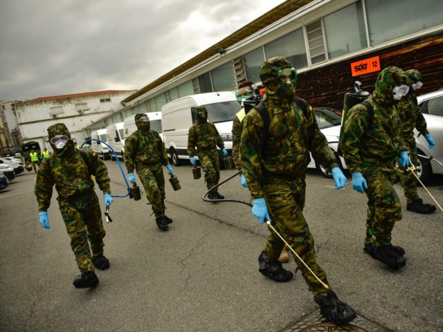 Member of Military Emergency Unit walk with special equipment to disinfect areas to prevent the spread of the coronavirus, arrive at Abando train station, in Bilbao, northern Spain, Monday, March 23, 2020. For some people the COVID-19 coronavirus causes mild or moderate symptoms, but for some it causes severe illness. …