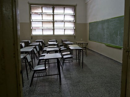 Desks sit empty in a public school classroom in a Buenos Aires suburb, Argentina, Wednesday, March 19, 2014. Striking teachers in the Buenos Aires province are demanding a wage increase higher than what is currently being offered by the provincial administration. The strike is in its 11th day, affecting more …