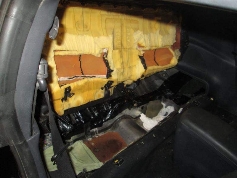 CBP officers find a hidden compartment in the rear seat of a Mitsubishi sedan used to smuggle a man into the U.S. (Photo: U.S. Customs and Border Protection/El Centro Sector)