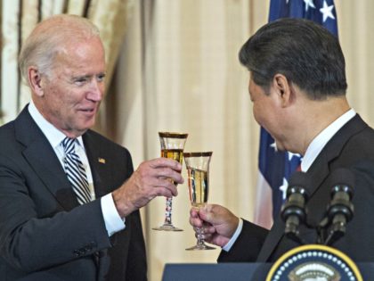 US Vice President Joe Biden and Chinese President Xi Jinping toast during a State Luncheon for China hosted by US Secretary of State John Kerry on September 25, 2015 at the Department of State in Washington, DC. AFP PHOTO/PAUL J. RICHARDS (Photo credit should read PAUL J. RICHARDS/AFP via Getty …