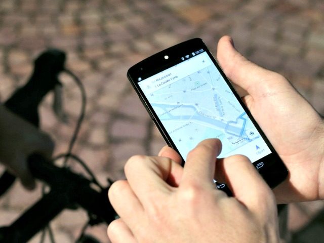 A man uses a GPS app on a smartphone during a Google promotion event at the City of Fashio