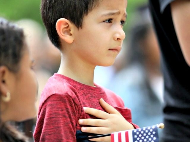 Children recite the Pledge of Allegiance during a citizenship ceremony on May 31 in Washin