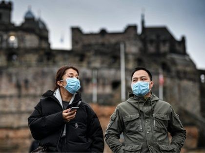 EDINBURGH, SCOTLAND - JANUARY 24: Tourists wear face masks as they visit Edinburgh Castle