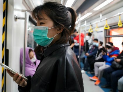 A commuter wears a protective mask in the subway on March 20, 2020 in Beijing, China. Since the new coronavirus covid-19 first emerged in late December 2019, more than 240,000 cases have been recorded in 150 countries and territories, killing more 10,000 people. (Photo by Lintao Zhang/Getty Images)