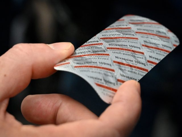 Medical staff shows on February 26, 2020 at the IHU Mediterranee Infection Institute in Marseille, a packet of Nivaquine, tablets containing chloroquine, a commonly used malaria drug that has shown signs of effectiveness against coronavirus, according to a study conducted in several Chinese hospitals. - The Mediterranee infection Institute in …