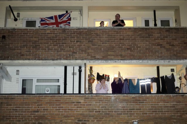 MANCHESTER, - MARCH 26: People applaud the NHS from their balconies and gardens across th