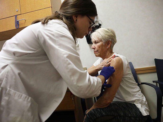 MIAMI, FL - OCTOBER 04: Luanne Boiko receives an influenza vaccination from nurse practitioner, Leslie Suarez, at the CVS Pharmacy store's MinuteClinic on October 4, 2018 in Miami, Florida. CVS stores will provide flu vaccinations at their MinuteClinic as well as the pharmacy and according to the Centers for Disease …