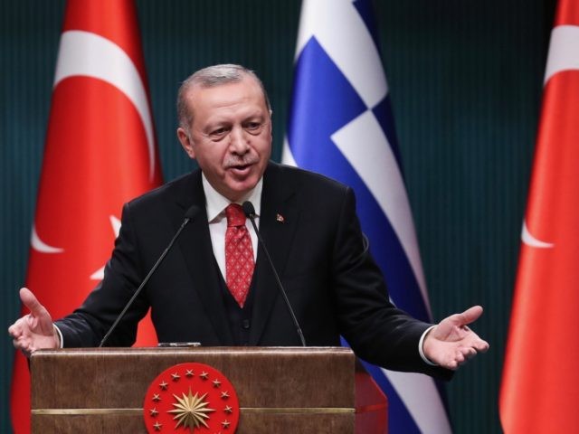 Turkish President Recep Tayyip Erdogan gestures as he delivers a speech during a joint pre