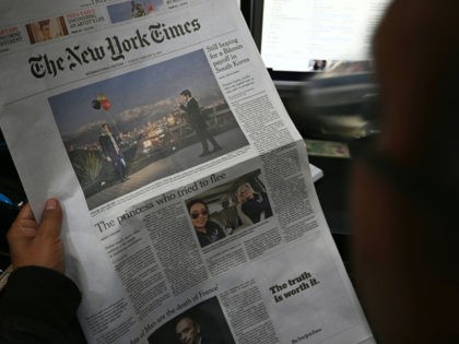 A Pakistani journalist reads a local edition of the International New York Times in Islama