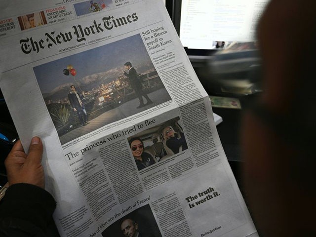 A Pakistani journalist reads a local edition of the International New York Times in Islamabad on February 12, 2019, which shows a single-column blank space on the front page. - An opinion piece in the International New York Times criticising Pakistan's powerful army was censored by its local publisher on …