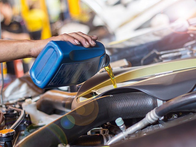 Hand mechanic in repairing car,change the oil close up selective focus