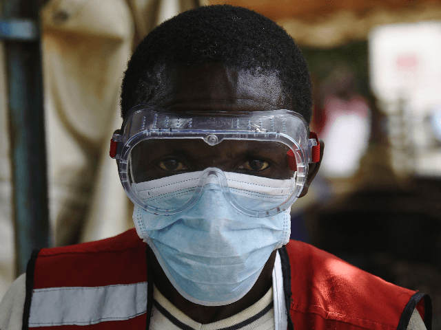 A health worker wears protective gears at the Mpondwe Health Screening Facility in the Uganda border town with the Democratic Republic of Congo, on June 13, 2019. - A grandmother in Uganda has died from Ebola, health officials said on June 12, 2019, the second fatality in the country since …