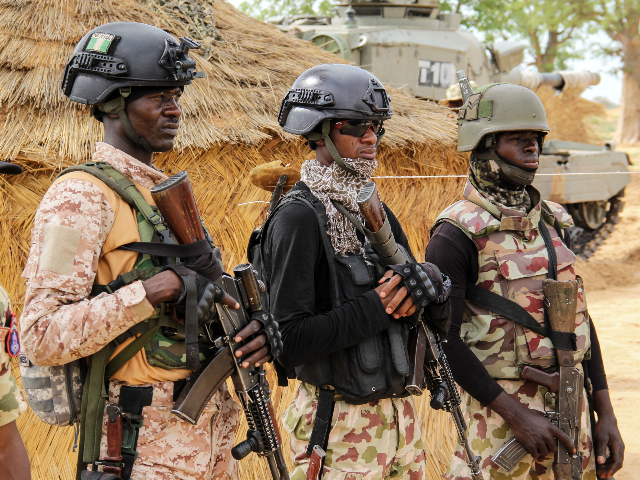 Nigerian Army soldiers stand at a base in Baga on August 2, 2019. - Intense fighting betwe