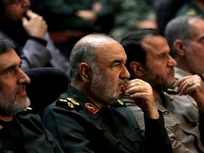 Iranian Revolutionary Guards commander Major General Hossein Salami (2-L) and General Amir Ali Hajizadeh (L), the head of the Revolutionary Guard's aerospace division, are pictured at Tehran's Islamic Revolution and Holy Defence museum, during the unveiling of an exhibition of what Iran says are US and other drones captured in …