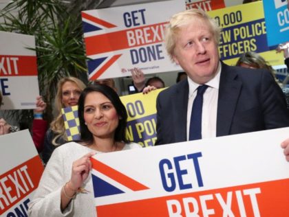 COLCHESTER, ENGLAND - DECEMBER 02: (L-R) Home Secretary Priti Patel, Prime Minister Boris Johnson and MP Will Quince hold a sign at a campaign rally event on December 2, 2019 in Colchester, England. (Photo by Hannah McKay - WPA Pool/Getty Images)