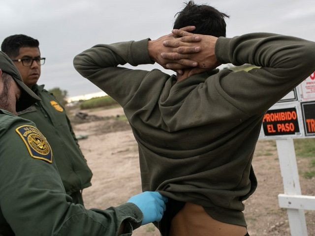U.S. Border Patrol agents detain undocumented immigrants caught near a section of privatel