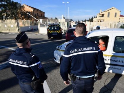 French gendarmes stadn guard as gendarmerie and French Red Cross vehicles arrive at the Is