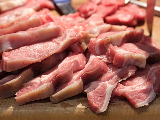 BERLIN, GERMANY - JANUARY 17: Slices of raw pork meat lie on a table for preparation at a