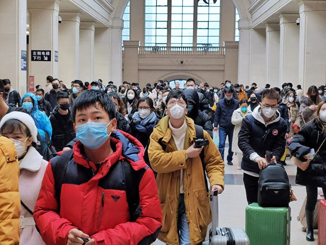 WUHAN, CHINA - JANUARY 22: People wear face masks as they wait at Hankou Railway Station on January 22, 2020 in Wuhan, China. A new infectious coronavirus known as "2019-nCoV" was discovered in Wuhan last week. Health officials stepped up efforts to contain the spread of the pneumonia-like disease which …