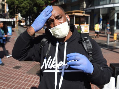 Cameron Nightingale adjusts his mask and gloves, a precaution to protect himself from coro