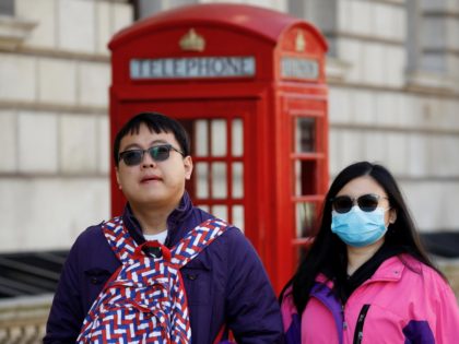 A tourist wears a surgical face mask as she walks past a red telephone box in central London on March 2, 2020. - Britain's Prime Minister Prime Minister on Monday chaired an emergency COBRA meeting on the coronavirus outbreak, after the number of confirmed cases of COVID-19 in the United …