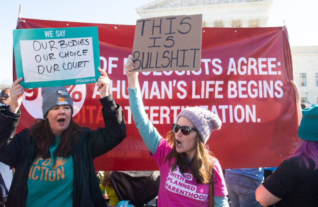 Anti-abortion protesters and pro-choice activists supporting legal access to abortion protest alongside each other during a demonstration outside the US Supreme Court in Washington, DC, March 4, 2020, as the Court hears oral arguments regarding a Louisiana law about abortion access in the first major abortion case in years. - The United States Supreme Court on Wednesday will hear what may be its most significant case in decades on the controversial subject of abortion. At issue is a state law in Louisiana which requires doctors who perform abortions to have admitting privileges at a nearby hospital. (Photo by SAUL LOEB / AFP) (Photo by SAUL LOEB/AFP via Getty Images)