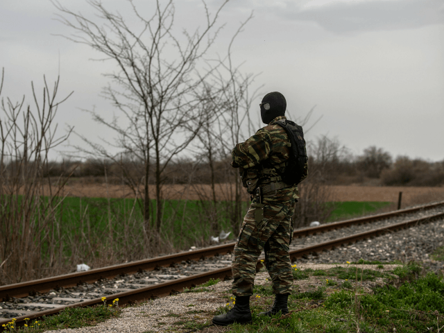 A Greek army officer patrols at the railway station of Kastanies village, near the Greek-T