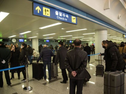 Foreign diplomats, embassy staff, and their families check-in for a flight to Vladivostok