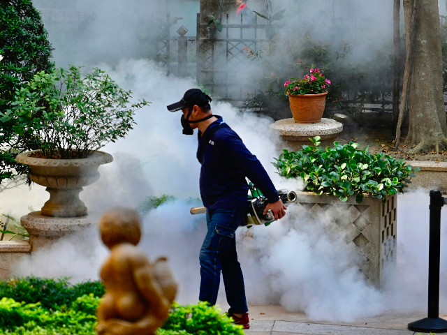 A mask-clad worker disinfects an area to prevent the spread of the COVID-19 coronavirus in Xindian district in New Taipei City on March 9, 2020. - World health officials have warned that countries are not taking the coronavirus crisis seriously enough, as outbreaks surged across Europe and in the United …