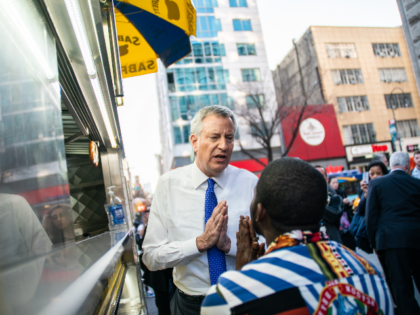 New York Mayor Bill De Blasio talks with a pedestrian Union Square to distribute informati