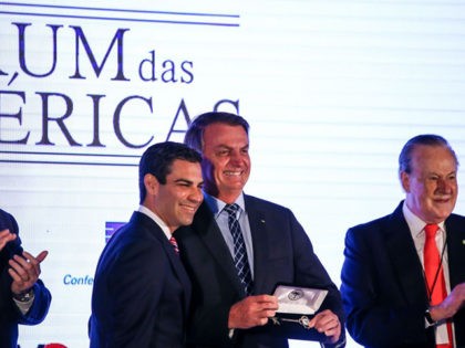Miami Mayor Francis Suarez gives Brazilian President Jair Bolsonaro(R) the keys to the city during the Forum Of The Americas at the InterContinental Miami in Miami, Florida on March 10, 2020. (Photo by Zak BENNETT / AFP) (Photo by ZAK BENNETT/AFP via Getty Images)