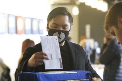 Matthew Guerrero, 22, of Des Moines, Washington wears a bear mask as he drops off his pres