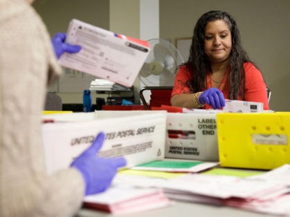 Ballot Processing Manager Jerelyn Hampton sorts vote-by-mail ballots by party for the presidential primary at King County Elections in Renton, Washington on March 10, 2020. (Photo by Jason Redmond / AFP) (Photo by JASON REDMOND/AFP via Getty Images)