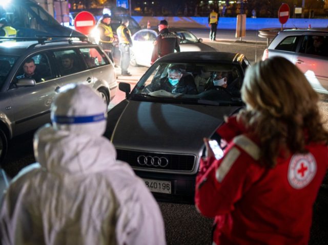 Motorists wait to have their body temperatures measured at the Slovenian-Italian border crossing near Nova Gorica, on March 11, 2020, after Slovenia's government announced it would close its border with Italy, hard hit by the outbreak of COVID-19, the new coronavirus. - Italy's neighbours Austria and Slovenia announced on March …