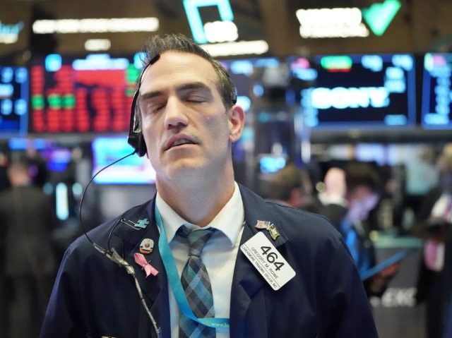 TOPSHOT - Traders work on the floor at the closing bell of the Dow Industrial Average at t