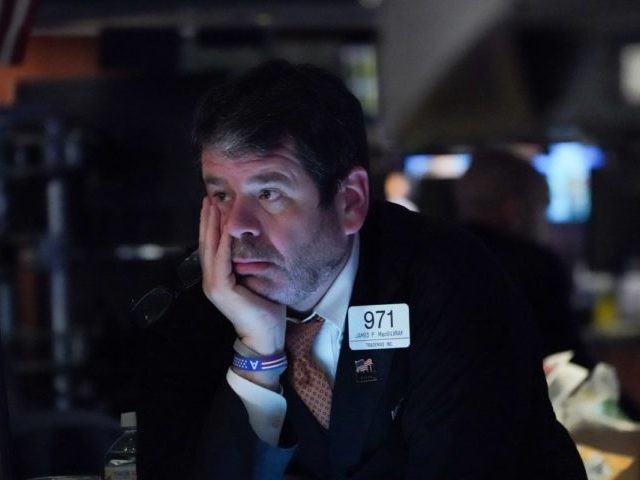 Traders work on the floor at the opening bell of the Dow Industrial Average at the New Yor