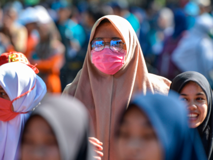 A woman wears a face mask at a public space in Banda Aceh on March 14, 2020. - As of March 13, there were over 140,000 confirmed cases of the COVID-19 illness in 124 countries, with more than 5,000 deaths. (Photo by CHAIDEER MAHYUDDIN / AFP) (Photo by CHAIDEER MAHYUDDIN/AFP …