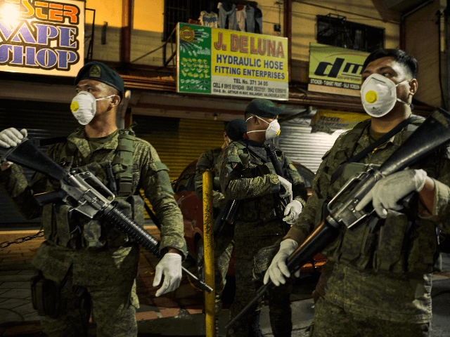 Philippine military prepare to setup a checkpoint in a main thoroughfare after president Duterte ordered a lockdown to contain the novel COVID-19 virus on March 15, 2020 in Meycauayan, north of Manila, Philippines. The Philippine government is placing some 12 million people in the capital Manila on lockdown as well …