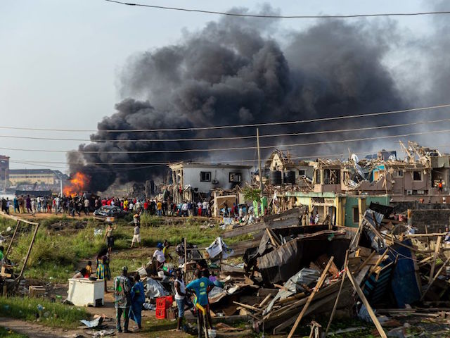This picture taken on March 15, 2020, shows scattered debris while a fire is still burning at the scene of a gas explosion in Lagos. - A gas explosion in Nigeria's commercial capital Lagos killed at least 15 people, injured many more and destroyed around 50 buildings on March 15, 2020. (Photo by Benson IBEABUCHI / AFP) (Photo by BENSON IBEABUCHI/AFP via Getty Images)