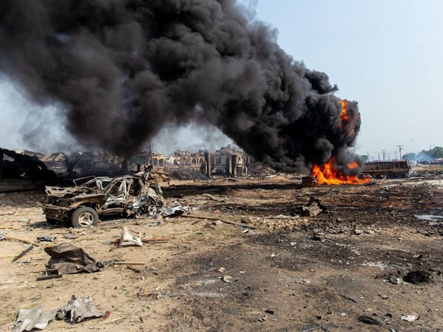 This picture taken on March 15, 2020, shows scattered debris while a fire is still burning after a gas explosion destroyed buildings and killed at least 15 people, in Nigeria's commercial capital Lagos. - A gas explosion in Nigeria's commercial capital Lagos killed at least 15 people, injured many more …