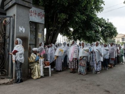 Ethiopian Orthodox female worshippers attend a service outside of the building due to the