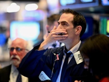 Traders work during the opening bell at the New York Stock Exchange (NYSE) on March 16, 20