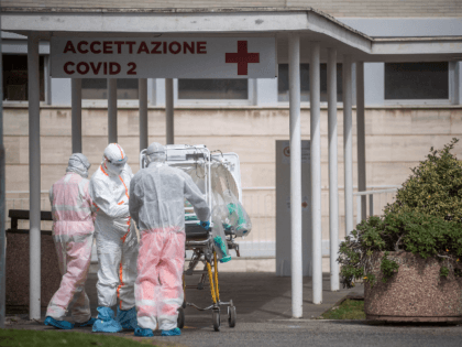 ROME, ITALY - MARCH 17: Medical staff collect a patient from an ambulance at the second Co