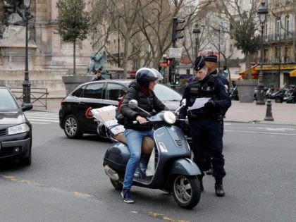 French police officers patrol and control citizens in Paris on March 17, 2020 while a stri