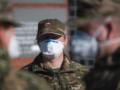 Members of Medical Unit of Slovenian Army wear face masks as they enter the facilities for