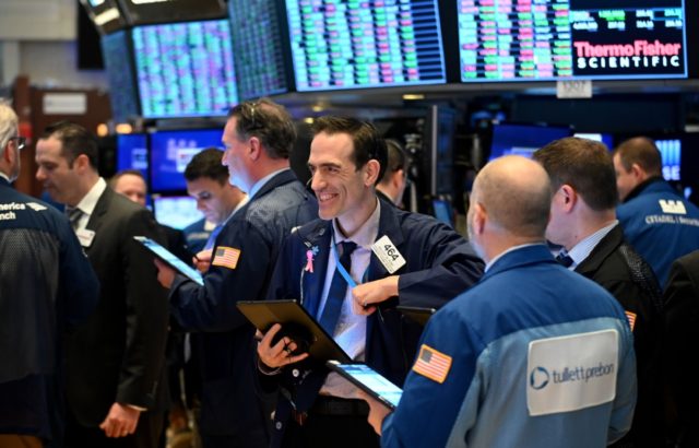 Traders work during the closing bell at the New York Stock Exchange (NYSE) on March 17, 20