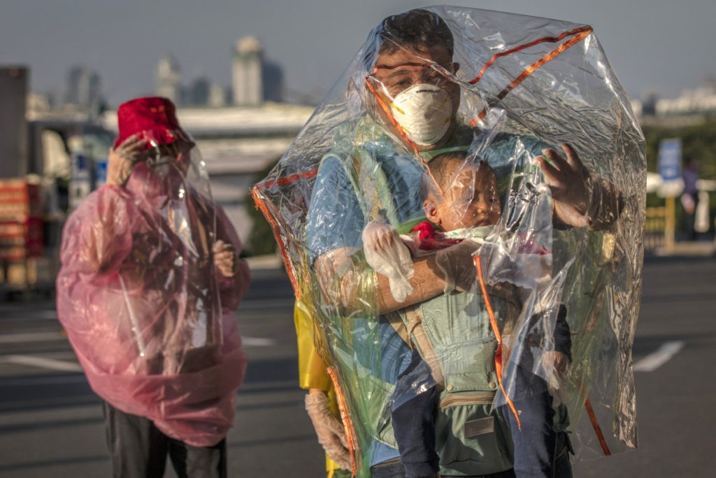 MANILA, PHILIPPINES - MARCH 18: Travelers are seen wearing raincoats, plastic covers, gloves, goggles, and facemasks as they wait for their flight at Ninoy Aquino International Airport on March 18, 2020 in Manila, Philippines. The Philippine government has sealed off Luzon, the country's largest and most populous island, to prevent the spread of COVID-19. Land, sea, and air travel has been suspended, while government work, schools, businesses, and public transportation have been ordered shut in a bid to keep some 55 million people at home. The Philippines' Department of Health has so far confirmed 202 cases of the new coronavirus in the country, with at least 17 recorded fatalities. (Photo by Ezra Acayan/Getty Images)