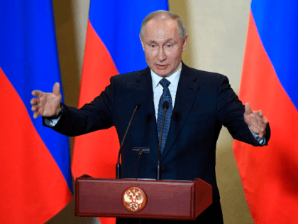 Russian President Vladimir Putin gives a speech during an awards ceremony for those who led the construction of the 19 kilometres (12 miles) road and rail Crimean Bridge over the Kerch Strait - that links mainland Russia to Moscow-annexed Crimea - in Sevastopol, Crimea, on March 18, 2020. (Photo by …