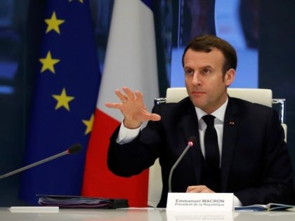 French President Emmanuel Macron gestures as he addresses a meeting at the emergency crisi