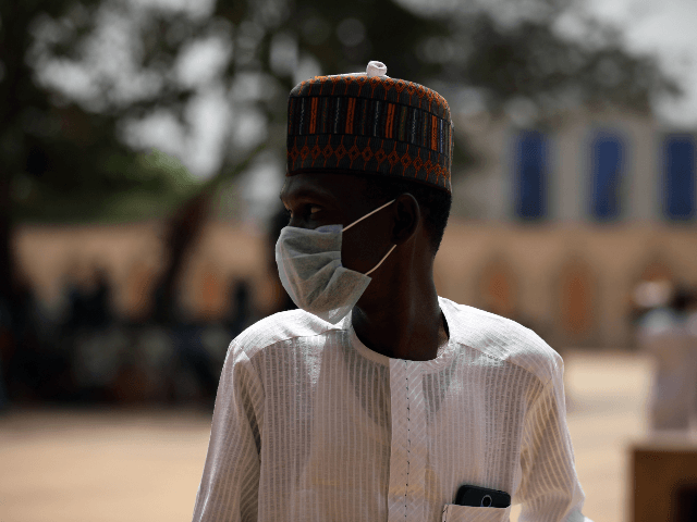 A Muslim faithful wears a face mask amid concerns of the spreading of the COVID-19 coronavirus at the National Mosque before the Friday prayers in Abuja, Nigeria, on March 20, 2020. - Nigeria said on March 19, 2020, it would shut schools and limit religious meetings in its economic hub …